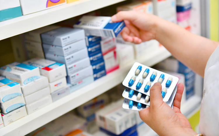 Pharmacist's hands holding medication