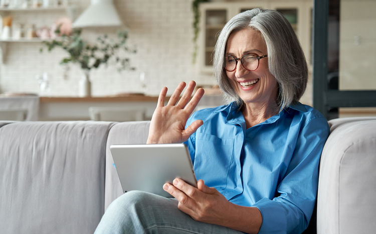 Middle,Aged,Adult,Woman,Waving,Hand at tablet