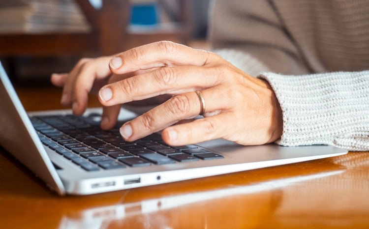 Close up of hands writing on keyboard laptop email or searching the net. People and online technology connection lifestyle. Working on the table with computer and software app