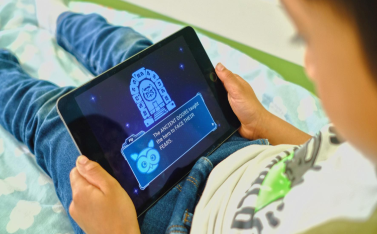 A young boy playing the Lumi Nova game on a tablet device